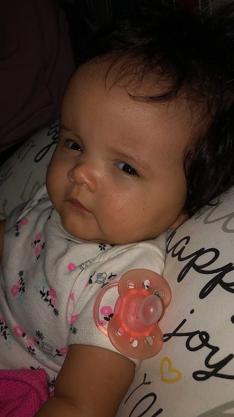 Calie is registered to the contest to win money with this photo: baby, baby_products, cheek, child, ear, eye, face, finger, head, iris, lip, mouth, neck, nose, person, pink, skin, toddler