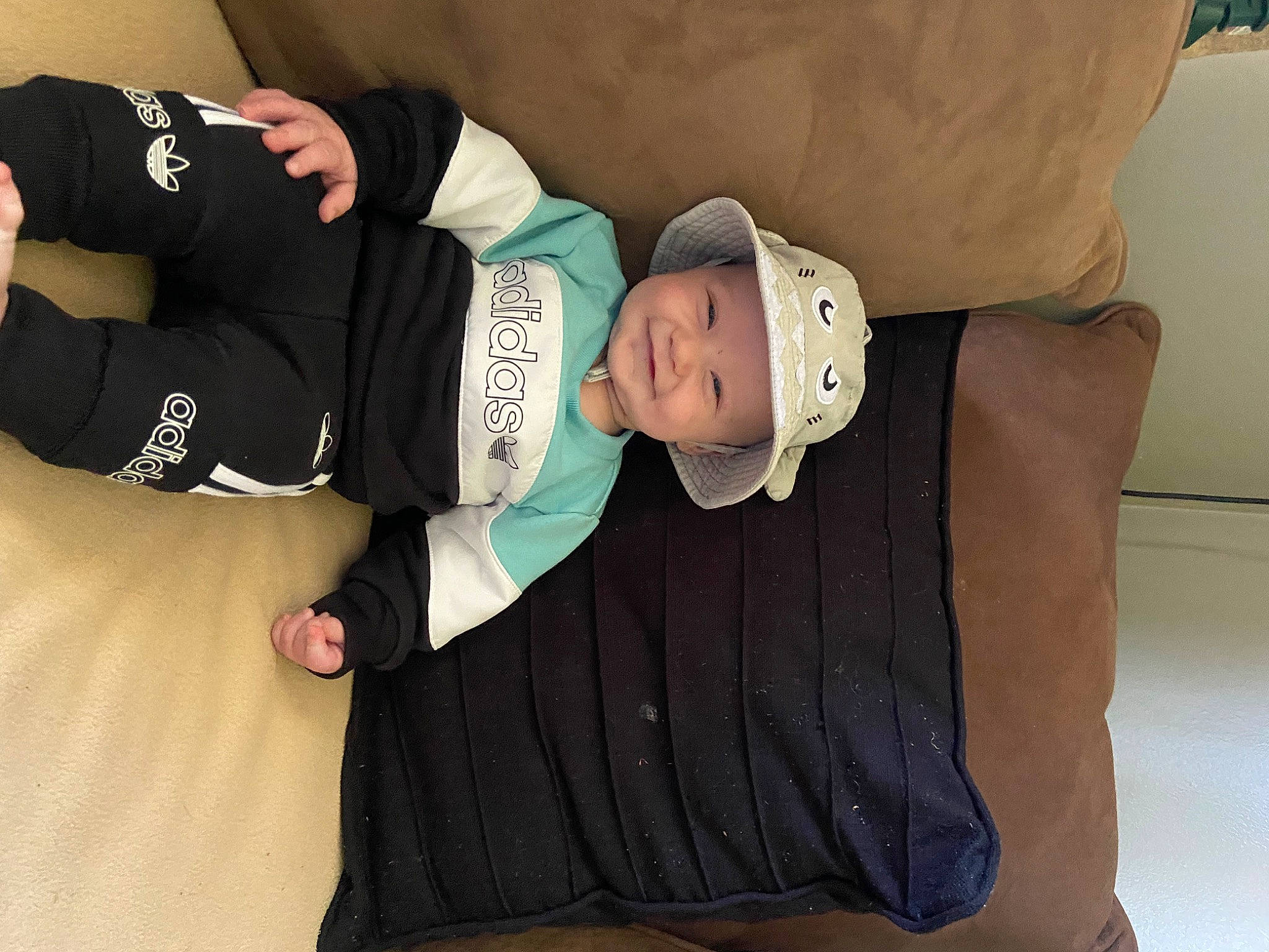 Kai joined the competition — help win amazing prizes! baby, baby_products, baby_toddler_clothing, child, comfort, elbow, fun, hat, headgear, headwear, human_body, human_leg, joy, knee, linens, person, room, sitting, sleeve, sock