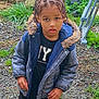 Kinsey a rejoint le concours — aidez-le/la à gagner de superbes lots ! black_shirt, braids, casual_clothing, child, curious, curly_hair, daylight, expression, fur_hood, garden, gravel, greenery, jacket, nature, outdoor, person, plants, portrait, standing, young