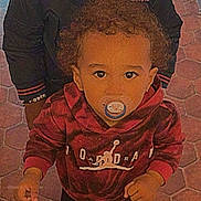 Kaylon participe au concours pour gagner de l'argent avec cette photo : baby, brick_floor, casual_wear, child, closeup, curly_hair, cute, hoodie, infant, looking_up, outdoor, pacifier, pattern, person, portrait, red_clothing, standing, sweatshirt, toddler, young_child
