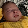Everleigh is registered to the contest to win money with this photo: baby, sleeping, yellow_clothing, blanket, infant, portrait, peaceful, cozy, face, child, soft_lighting, indoors, resting, cute, head, newborn, texture, patterned_blanket, warm, closeup