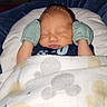 Robert is registered to the contest to win money with this photo: newborn, baby, sleeping, mittens, blanket, cushion, infant, cozy, bedtime, portrait, child, resting, cute, soft, indoor, peaceful, young, person, wrapped, nursery