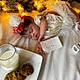 Blessmarie is registered to the contest to win money with this photo: baby, sleeping, holiday, christmas, milk, cookies, note, headband, white_clothing, blanket, christmas_tree, lights, festive, infant, tablecloth, decoration, cute, holiday_season, child, holiday_spirit