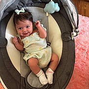 Blessmarie is registered to the contest to win money with this photo: baby, infant, smiling, child, baby_seat, clothing, socks, bow, toy, fabric, floor, pink_rug, happy, cute, indoor, person, portrait, baby_girl, soft_texture, relaxing