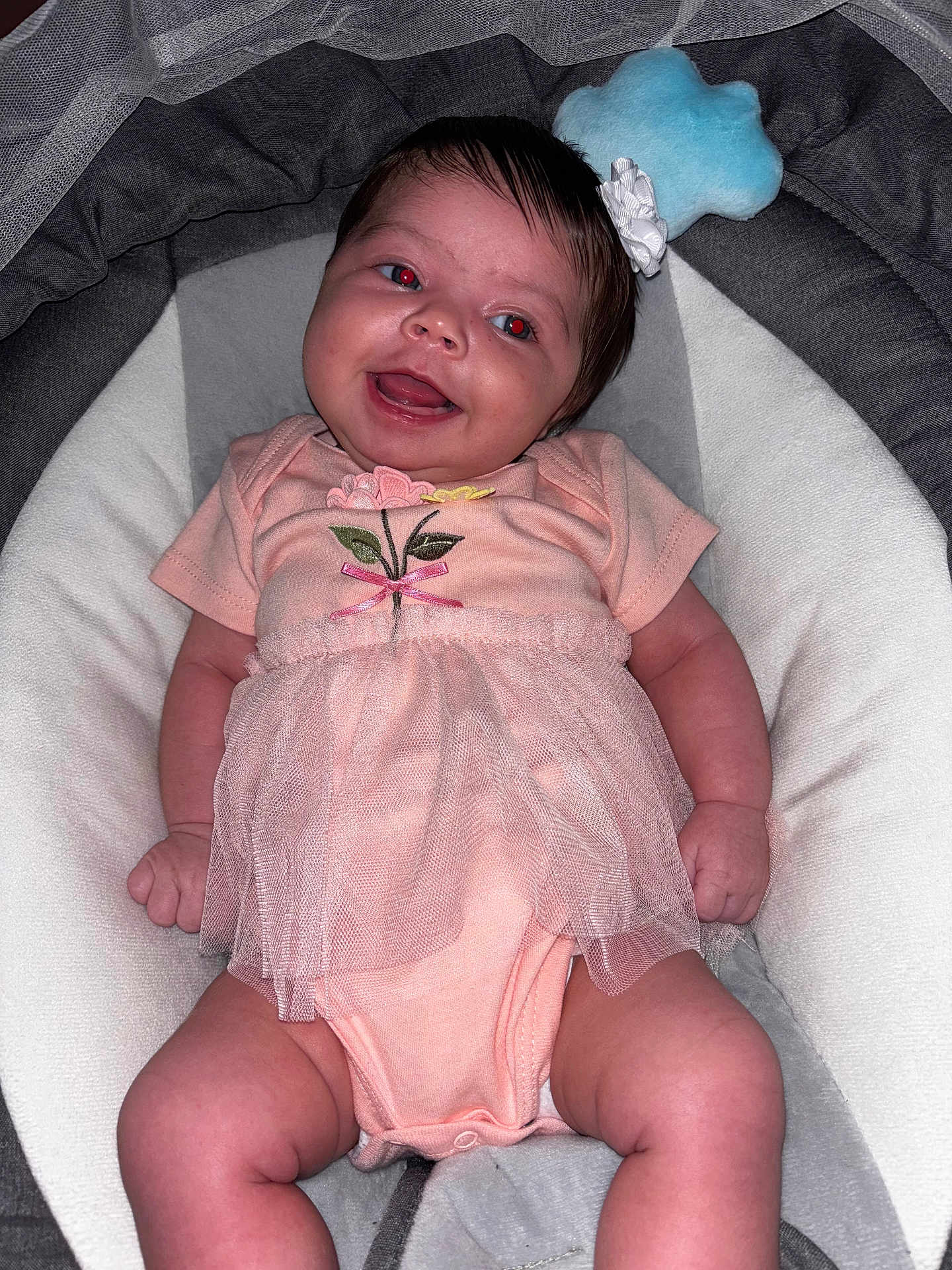 Blessmarie is registered to the contest to win money with this photo: baby, infant, smiling, pink_dress, flower_embroidery, baby_seat, cushion, cute, red_eye, happy, small_hands, small_legs, indoor, portrait, child, newborn, soft_toys, head_accessory, white_cushion, cozy