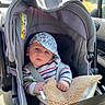 Isandro a rejoint le concours — aidez-le/la à gagner de superbes lots ! baby, blanket, cap, car, car_interior, car_seat, child, clothing, cozy, cute, infant, person, portrait, safety, seatbelt, sitting, striped_pajamas, sunlight, travel, window
