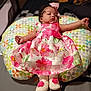 baby, infant, child, dress, floral_pattern, pink, headband, bow, cushion, colorful, pattern, footwear, booties, lying_down, indoor, soft_lighting, cute, portrait, person, resting