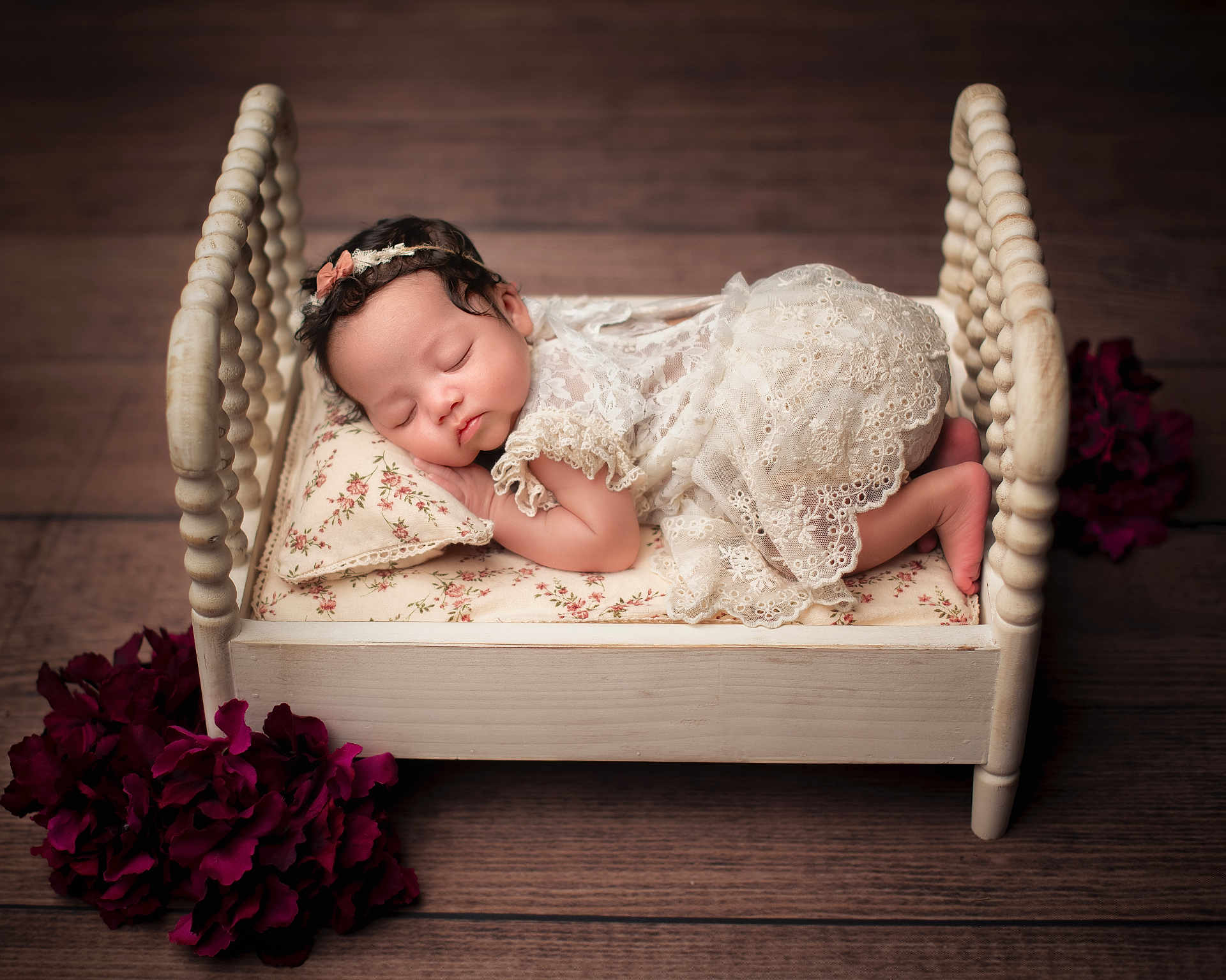 Musica is registered to the contest to win money with this photo: baby, sleeping, lace_dress, bed, pillow, wooden_bed, flower, purple_flower, infant, headband, portrait, cute, peaceful, indoors, floor, child, soft_lighting, small_bed, resting, decor