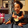 Musica is registered to the contest to win money with this photo: baby, bed, child, curly_hair, curtain, cute, dress, dresser, foot, hand, headband, indoors, milestone_sign, mirror, person, plush_toy, portrait, room, toddler, unicorn