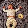 Musica joined the competition — help win amazing prizes! baby, infant, child, pajamas, patterned_blanket, milestone_marker, 2_months, smiling, lying_down, cute, cartoon_print, wooden_marker, arms_outstretched, cozy, indoors, portrait, happy, face, feet, clothing