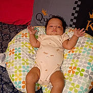 Musica is registered to the contest to win money with this photo: arms, baby, bed, bedding, child, clothing, colorful, cute, face, indoors, infant, legs, patterned, person, pillow, relaxed, resting, sleeping_area, textile, young