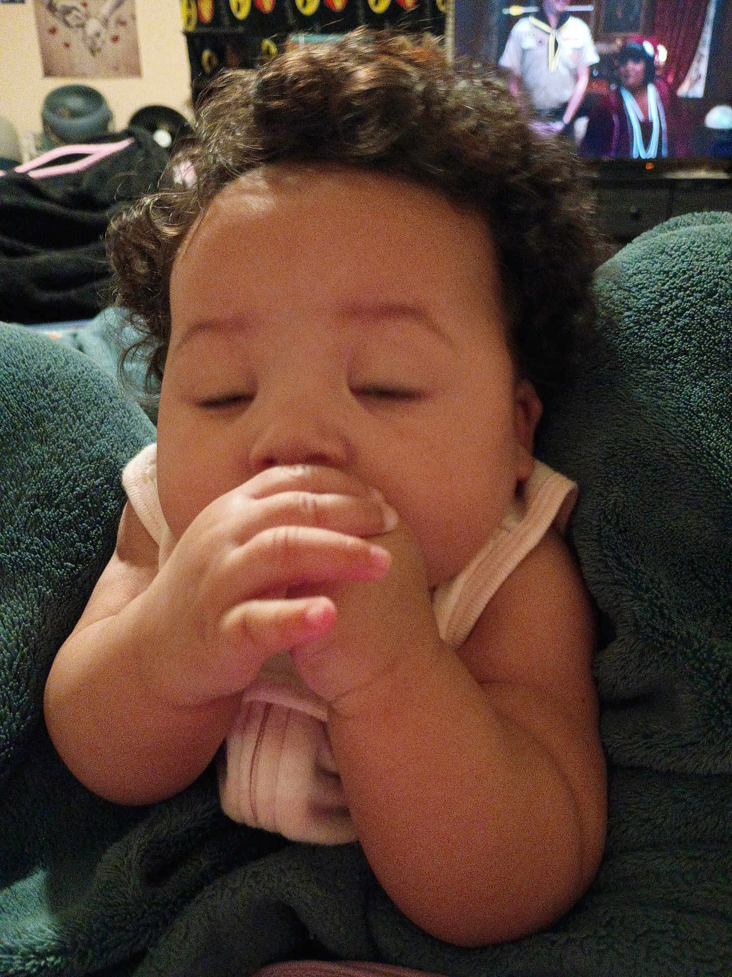 Musica is registered to the contest to win money with this photo: baby, curly_hair, blanket, sleepy, hand, infant, closeup, indoors, soft, cozy, child, skin, face, cute, resting, person, comfort, nap, warm, relaxed