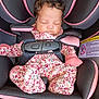 baby, sleeping, car_seat, evenflo, pink, black, floral, onesie, mittens, child, infant, seatbelt, safety, curly_hair, peaceful, indoors, closeup, portrait, cute, resting