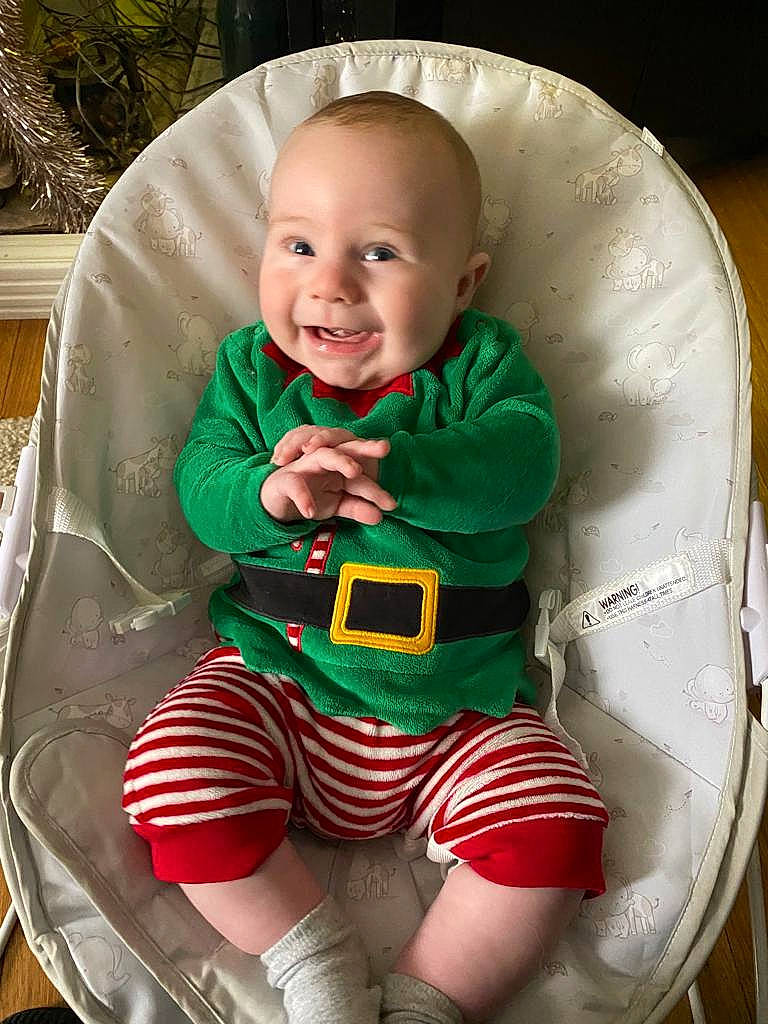 Jenson is registered to the contest to win money with this photo: baby, baby_products, baby_toddler_clothing, chair, comfort, eye, face, flowerpot, fun, hairstyle, happy, head, human_body, joy, mouth, person, sitting, sleeve, smile, t_shirt