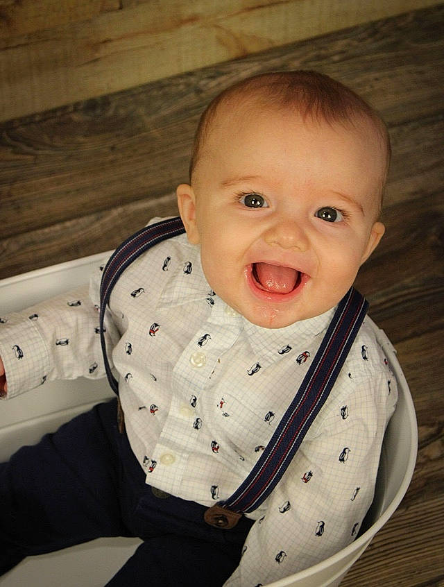 William is registered to the contest to win money with this photo: baby, cheek, child, chin, eye, face, facial_expression, forehead, head, iris, joy, lip, mouth, neck, nose, outerwear, person, product, sitting, skin