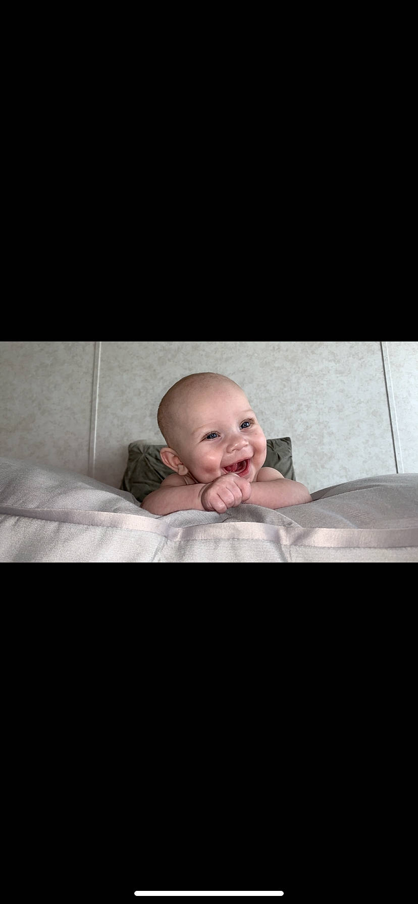 Carrie is registered to the contest to win money with this photo: baby, bedding, comfort, darkness, eyebrow, flash_photography, floor, flooring, fun, happy, laugh, linens, monochrome, monochrome_photography, person, portrait, portrait_photography, room, sitting, smile