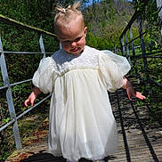 Ameliia participe au concours pour gagner de l'argent avec cette photo : baby, bridge, child, cute, daytime, dress, exploring, greenery, hair_ties, nature, outdoor, park, person, sandals, shadow, sunlight, toddler, white_dress, wooden_bridge, young_child