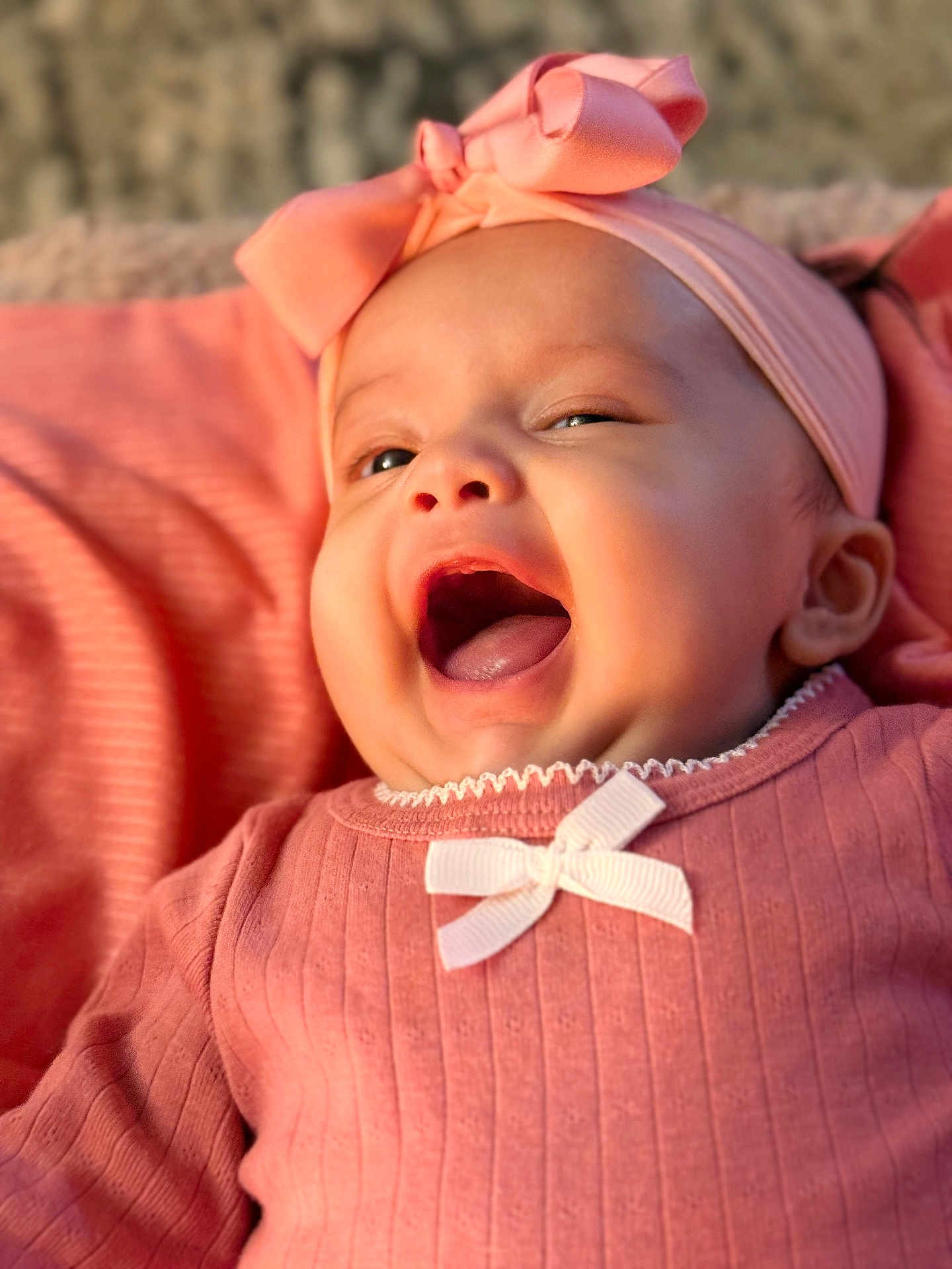 Evaana Dahal is registered to the contest to win money with this photo: baby, infant, pink_clothing, headband, bow, smiling, happy, cute, closeup, portrait, child, soft_light, indoors, skin, face, mouth_open, eyes, apparel, young_child, cozy