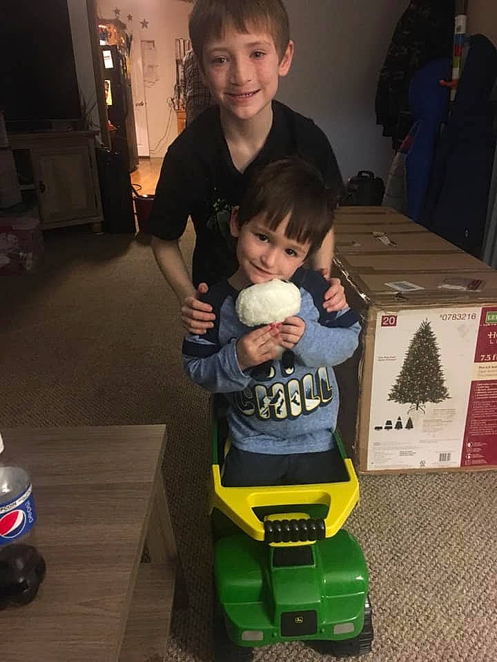 Jacob is registered to the contest to win money with this photo: baby, bag, child, face, flooring, fun, head, joy, luggage_and_bags, person, plastic_bottle, product, recreation, riding_toy, room, sitting, smile, t_shirt, tire, toddler