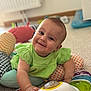 Lya participe au concours pour gagner de l'argent avec cette photo : baby, child, smiling, green_clothing, toy, indoor, playmat, colorful, happy, infant, cute, hand, face, person, patterned, floor, bright, play, crawling, young