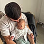 Lya participe au concours pour gagner de l'argent avec cette photo : baby, man, child, person, indoor, sitting, white_shirt, facial_hair, chair, clothing, floor_tile, blanket, arm, head, hair, comfort, casual, holding, parent, home