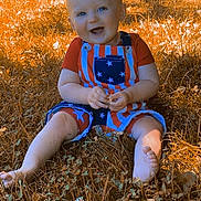 Cayson joined the competition — help win amazing prizes! baby, child, infant, smiling, happy, outdoor, grass, lawn, sitting, portrait, face, blue_eyes, overalls, striped_clothing, star_pattern, barefoot, sunlight, autumn, backyard, photography