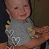 Cayson joined the competition — help win amazing prizes! baby, infant, child, smiling, portrait, indoors, adult, arms, holding, gray_shirt, short_sleeves, face, eyes, hair, heart_doodles, seated, cuddling, family, close_up, happy
