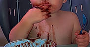 Cayson is registered to the contest to win money with this photo: baby, child, high_chair, chocolate, messy, eating, spoon, bowl, dessert, food, smiling, blue_eyes, portrait, indoor, kitchen, seated, feeding, infant, heart_filter, funny