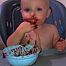 baby, child, high_chair, chocolate, messy, eating, spoon, bowl, dessert, food, smiling, blue_eyes, portrait, indoor, kitchen, seated, feeding, infant, heart_filter, funny