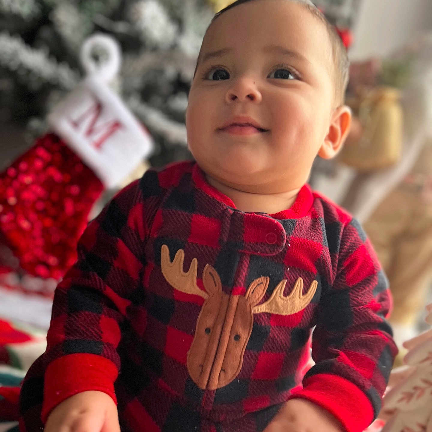 Jeyden joined the competition — help win amazing prizes! baby, black, blurred_background, child, christmas_tree, cozy, cute, face, festive, hands, happy, holiday, indoors, moose, onesie, plaid, portrait, red, smile, stocking