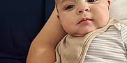 Anthony joined the competition — help win amazing prizes! baby, infant, child, person, arm, clothing, bib, striped, face, skin, couch, furniture, indoors, relaxing, comfort, home, casual, portrait, young, seated