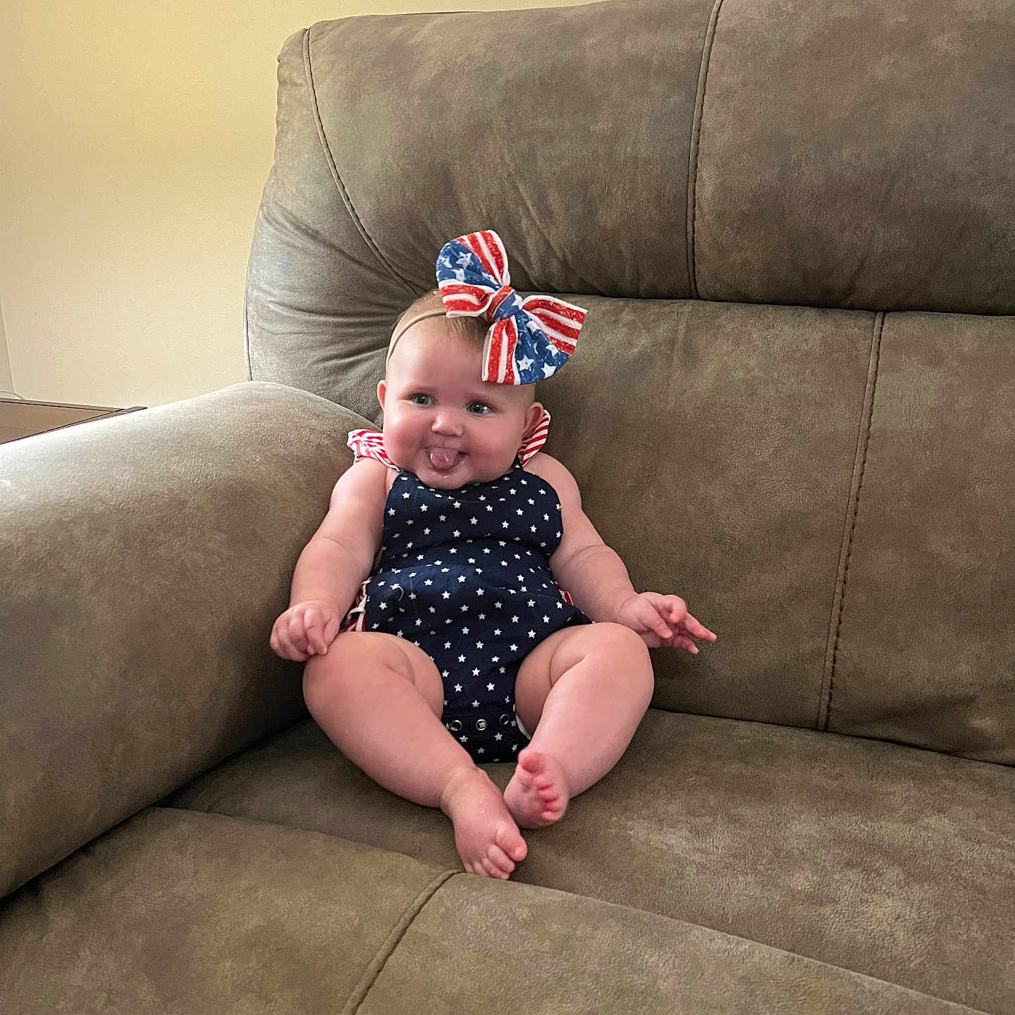 Riley joined the competition — help win amazing prizes! americanflag, architecture, baby, building, chair, clothing, couch, cushion, face, flag, furniture, head, homedecor, indoors, livingroom, person, photography, portrait, room, sitting
