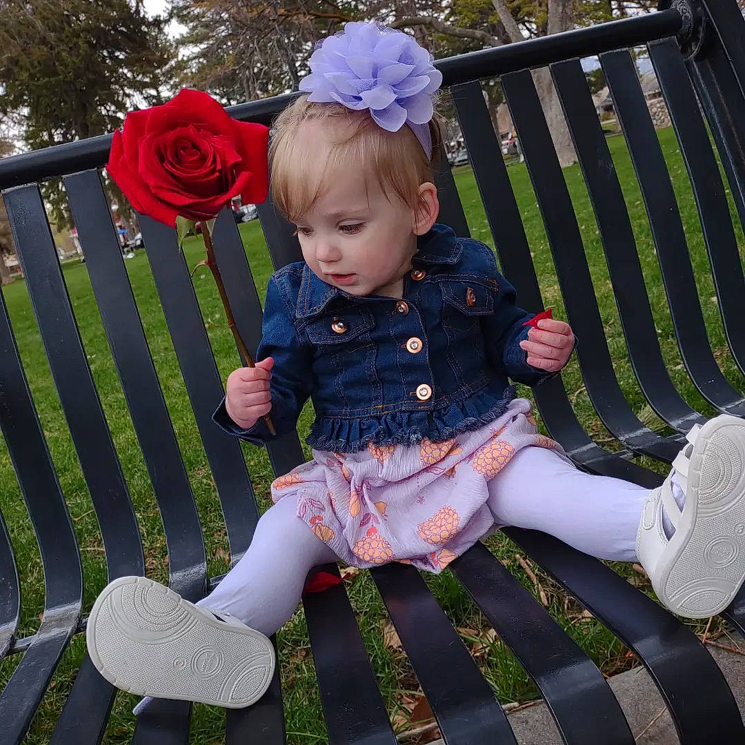 Jacklynn is registered to the contest to win money with this photo: baby, baby_toddler_clothing, bench, chair, dress, flower, footwear, grass, hat, lap, leg, outdoor_furniture, pattern, person, pink, plant, product, shoe, textile, thigh