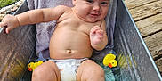 Alexzander joined the competition — help win amazing prizes! baby, water, rubber_duck, tub, diaper, smile, towel, outdoor, grass, wooden_deck, metal_container, child, playful, cute, relaxing, summer, bare_chest, infant, water_play, cheeky