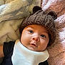 Alexzander joined the competition — help win amazing prizes! baby, infant, face, hat, knit_hat, bear_ears, bib, blanket, soft_texture, pink_blanket, white_blanket, black_clothing, cute, cozy, portrait, lying_down, child, young_child, indoors, closeup