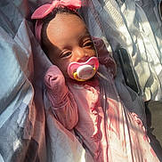 Dalaysia joined the competition — help win amazing prizes! baby, pacifier, headband, pink_clothing, bedspread, sunlight, infant, sleepwear, blanket, indoor, resting, cute, child, face, hands, soft_light, pattern, cozy, portrait, sleeping