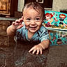 baby, child, crawling, wet_hair, smiling, happy, floor, water, reflection, indoor, cartoon_background, blue_clothing, cute, playful, young_child, face, hand, eyes, person, infant