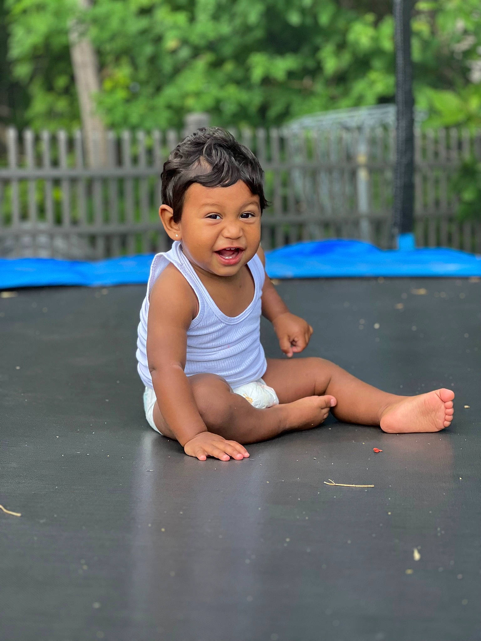 Santino is registered to the contest to win money with this photo: asphalt, barefoot, child, electric_blue, facial_expression, flash_photography, flooring, foot, fun, grass, happy, human_leg, leisure, person, play, recreation, road, sitting, t_shirt, thigh