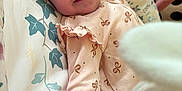 Evelyn is registered to the contest to win money with this photo: baby, smiling, onesie, infant, soft_toy, cushion, floral_pattern, indoor, cute, child, sleepwear, happy, face, comfort, closeup, baby_girl, pink, plush, portrait, cozy