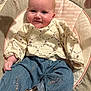 Evelyn is registered to the contest to win money with this photo: baby, infant, smile, face, clothing, denim, pattern, cushion, seat, indoor, child, cute, happy, portrait, sitting, apparel, fabric, person, young, cozy