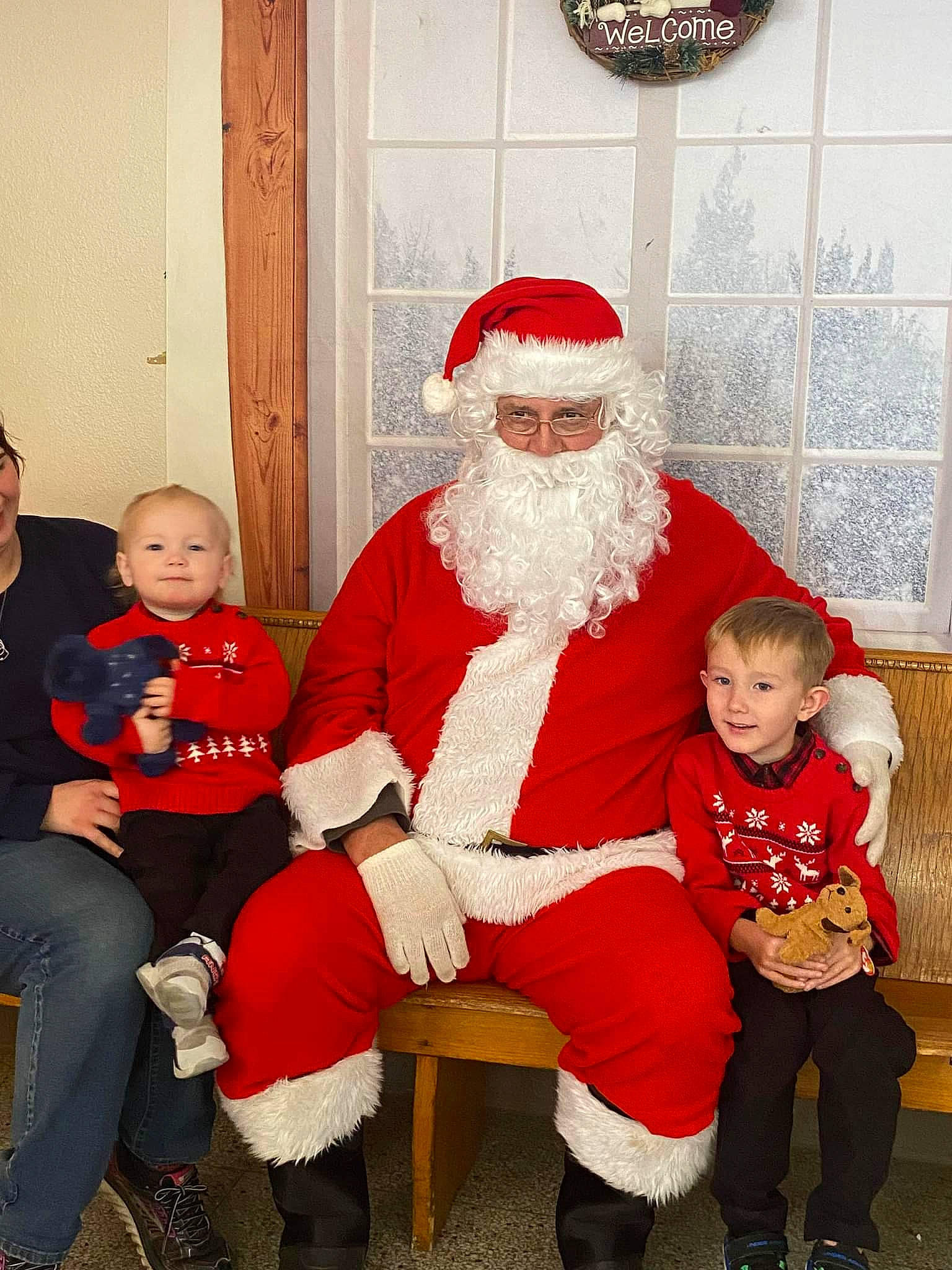 Broderick joined the competition — help win amazing prizes! beard, boot, christmas, christmas_eve, event, face, fictional_character, fun, fur, happy, hat, headwear, holiday, joy, lap, person, red, santa_claus, sitting, toddler