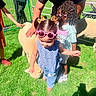 Maddie is registered to the contest to win money with this photo: children, toddler, girl, outdoor, sunlight, sheep, animal_encounter, sunglasses, pigtails, hair_bows, blue_dress, t_shirt, grass, playground, petting_zoo, family, adults, stroller, smiling, summer