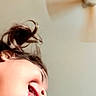 Maddie is registered to the contest to win money with this photo: child, toddler, face, portrait, playful, silly, tongue, smiling, hair, indoors, ceiling_fan, home, wall, close_up, profile, funny, casual, photography, warm_lighting, expression