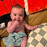 Caden joined the competition — help win amazing prizes! baby, child, infant, smiling, portrait, sitting, blanket, cushions, pillow, checkered_pattern, colorful, indoors, cozy, happy, face, hands, fingers, bare_shoulders, furniture, photography