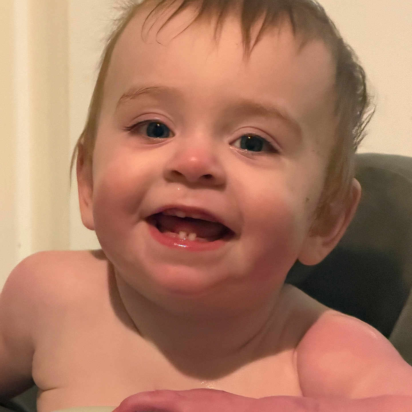 Caden is registered to the contest to win money with this photo: baby, child, infant, smiling, laughing, portrait, face, eyes, teeth, hair, indoor, warm_lighting, close_up, bare_shoulders, hand, toy, handle, chair, happy, photography