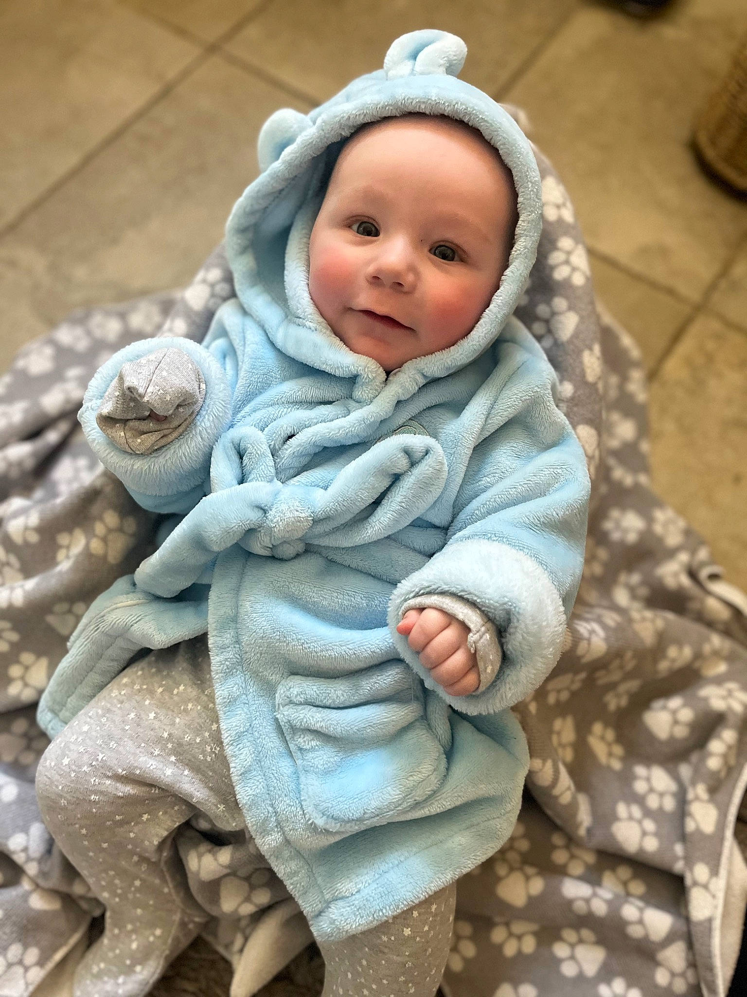 Thodore is registered to the contest to win money with this photo: baby, baby_toddler_clothing, camouflage, cap, cheek, child, comfort, face, fur, gesture, headwear, linens, military_camouflage, outerwear, person, sitting, skin, sleeve, smile, textile