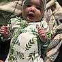 Emory joined the competition — help win amazing prizes! baby, infant, smiling, headband, bow, leaf_pattern, onesie, blanket, cozy, happy, cute, face, hands, lying_down, green, white, fabric, child, person, portrait
