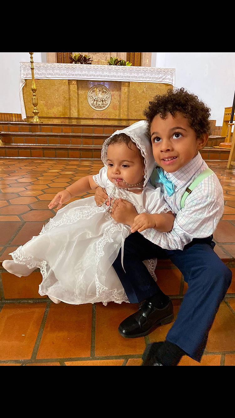 Micaela is registered to the contest to win money with this photo: baby, baby_toddler_clothing, bridal_clothing, dress, event, face, flash_photography, flooring, formal_wear, fun, gesture, gown, happy, headpiece, interaction, iris, joy, leg, person, skin