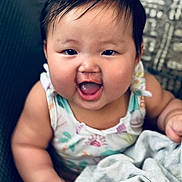 Linoa Grace joined the competition — help win amazing prizes! baby, child, smiling, happy, face, person, infant, cute, cheeks, clothing, blanket, sitting, indoors, portrait, head, hair, skin, expression, young, colorful