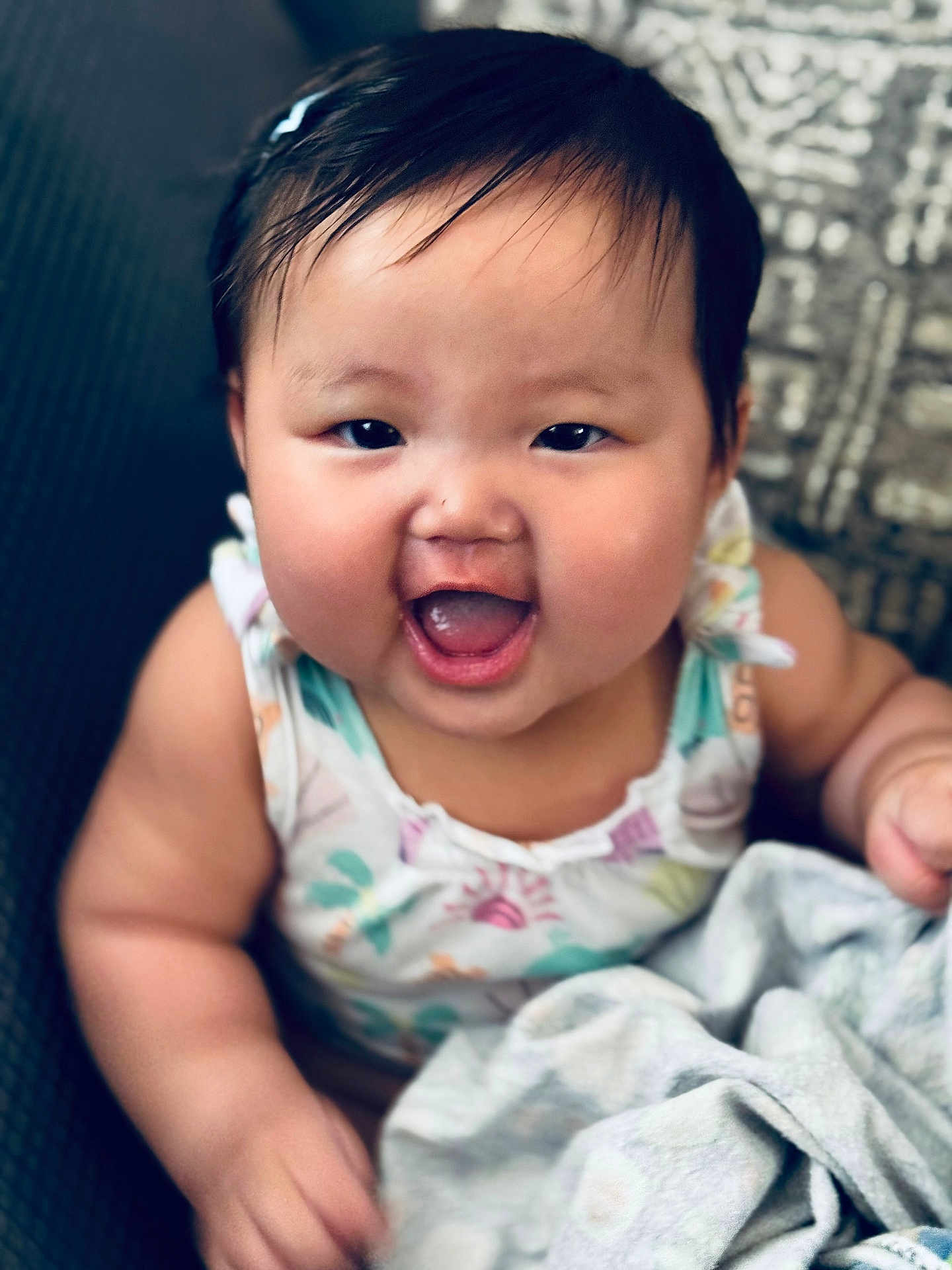 Linoa Grace joined the competition — help win amazing prizes! baby, child, smiling, happy, face, person, infant, cute, cheeks, clothing, blanket, sitting, indoors, portrait, head, hair, skin, expression, young, colorful